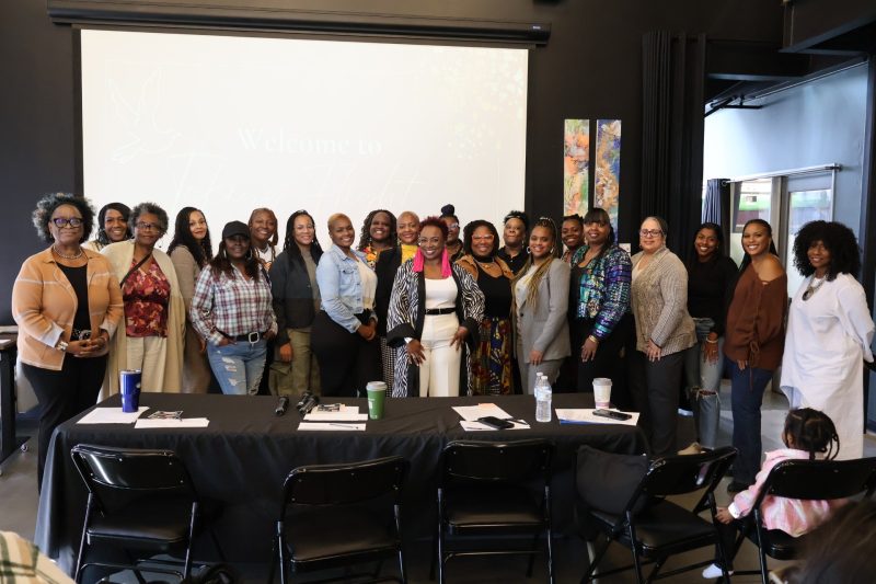 A group of over 20 African-American women participating in a business pitch competition.